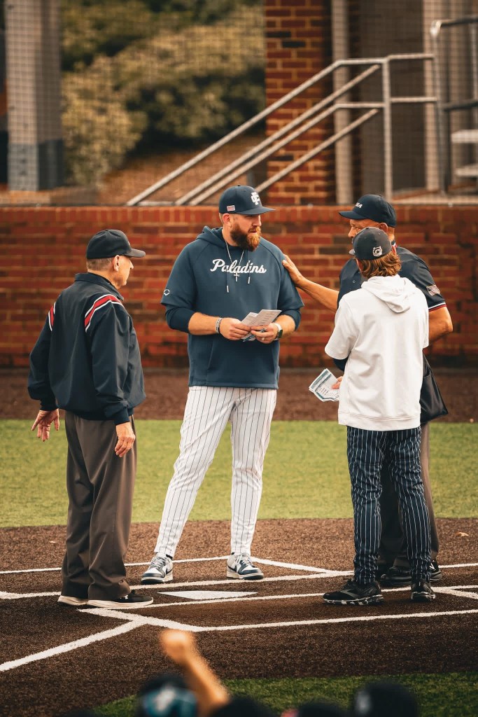 Shawn Oliver in plate meeting with umpires